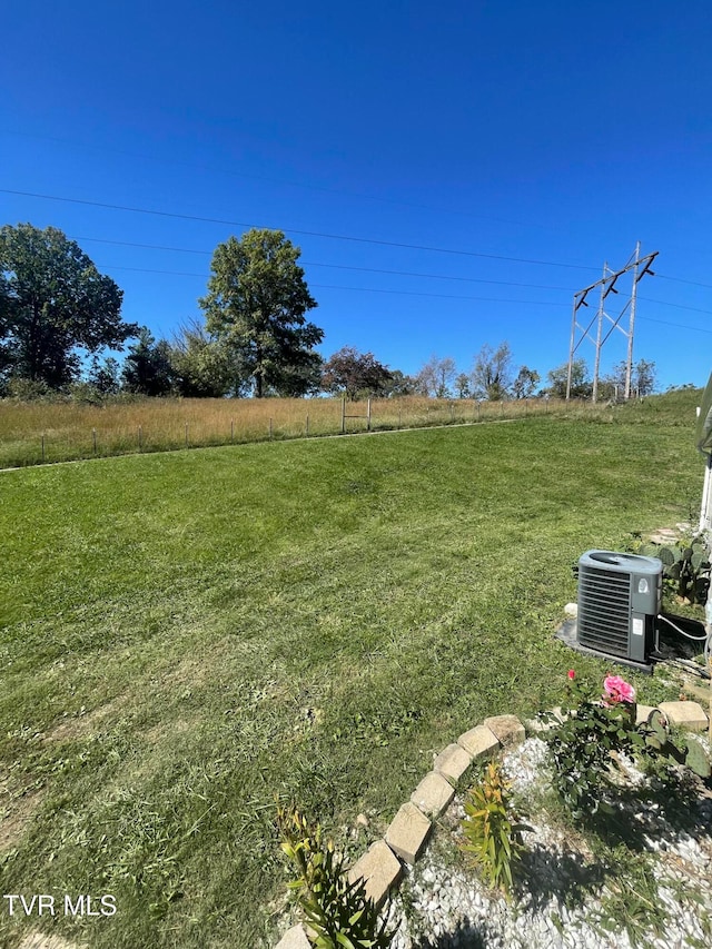 view of yard with a rural view and central AC