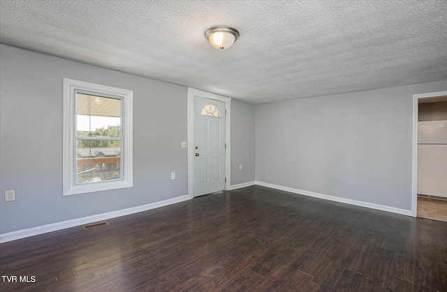 entryway featuring dark hardwood / wood-style flooring and a textured ceiling