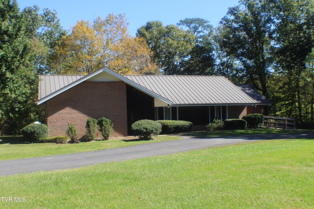 view of side of property with a lawn