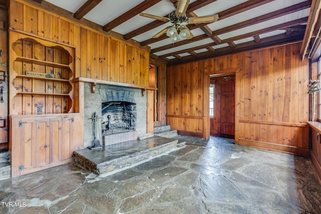 120 Rock Rd, Bristol, TN 37620 - unfurnished living room featuring stone floors, wood walls, beamed ceiling, a ceiling fan, and a stone fireplace