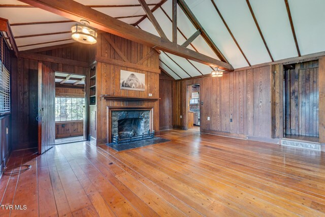 120 Rock Rd, Bristol, TN 37620 - unfurnished living room with wood walls, wood-type flooring, and a premium fireplace