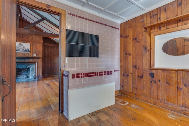 120 Rock Rd, Bristol, TN 37620 - kitchen with hardwood / wood-style flooring, a fireplace, wooden walls, and stainless steel counters
