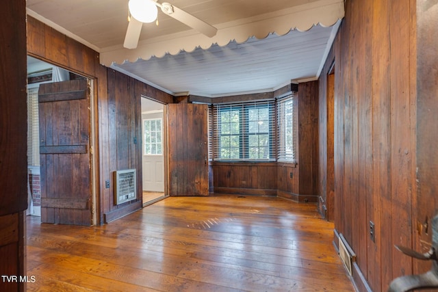 120 Rock Rd, Bristol, TN 37620 - empty room featuring heating unit, wood-type flooring, wooden walls, crown molding, and ceiling fan