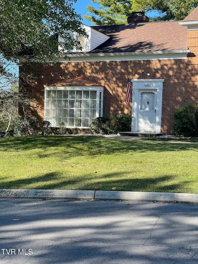 doorway to property with a yard