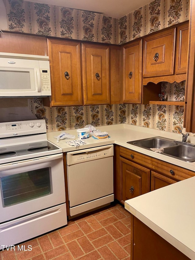 kitchen featuring sink and white appliances