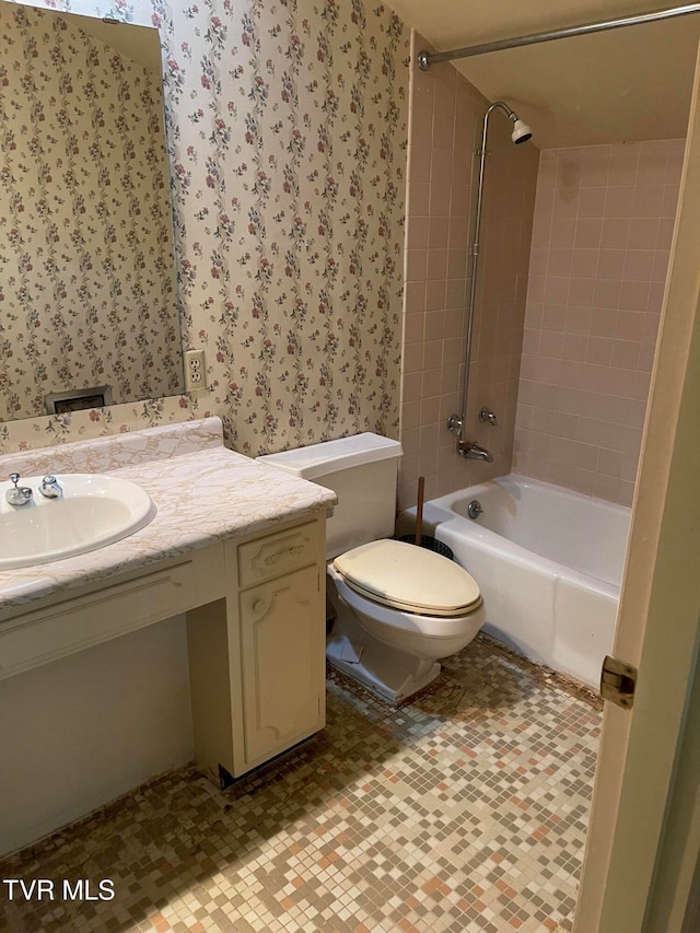 full bathroom featuring vanity, toilet, and tiled shower / bath combo