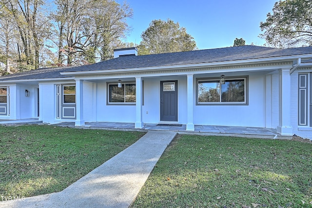 view of front of house featuring a front yard and covered porch