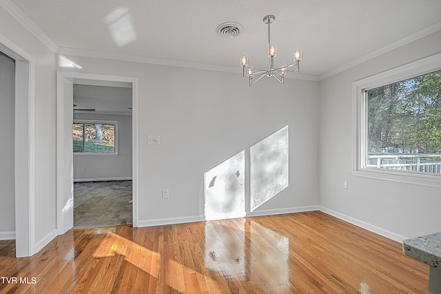 interior space with ornamental molding, a healthy amount of sunlight, a chandelier, and light hardwood / wood-style flooring