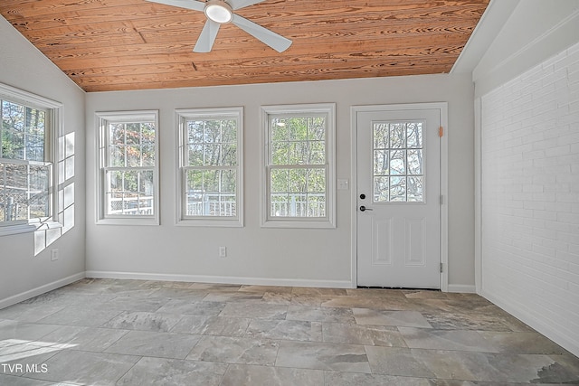 interior space featuring ceiling fan, vaulted ceiling, and wooden ceiling