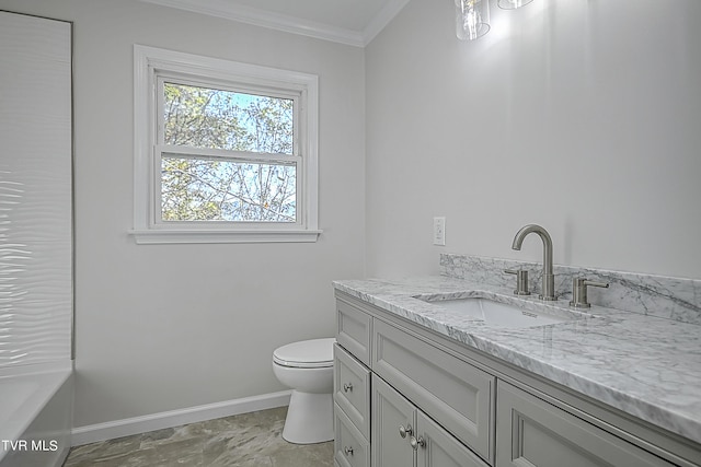 bathroom featuring crown molding, a washtub, vanity, and toilet