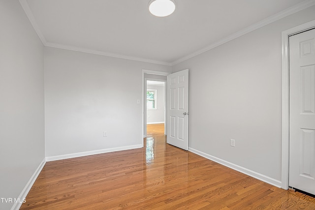 unfurnished room featuring crown molding and light hardwood / wood-style flooring