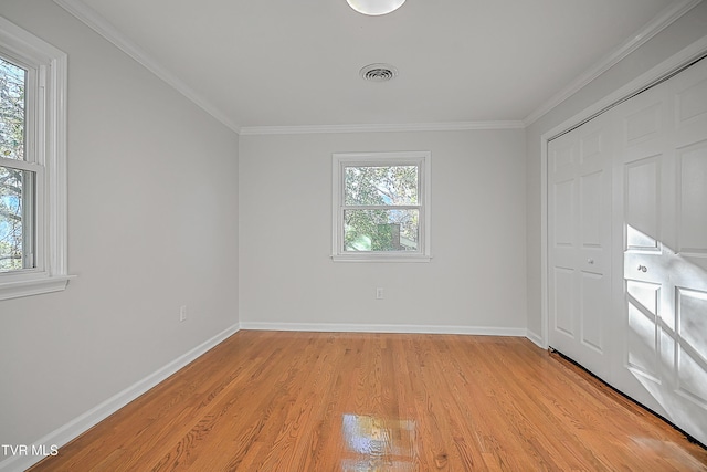 unfurnished bedroom featuring light hardwood / wood-style floors and multiple windows