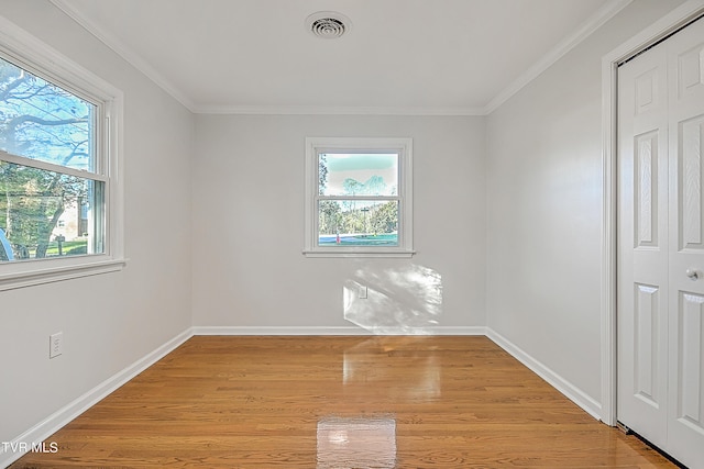 unfurnished room with ornamental molding and light hardwood / wood-style flooring