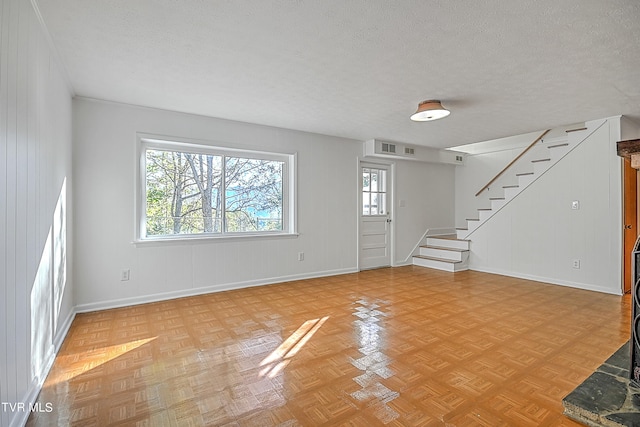 interior space featuring light parquet flooring and a textured ceiling