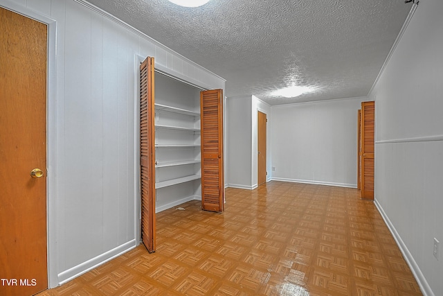 unfurnished bedroom featuring ornamental molding, light parquet floors, and a textured ceiling