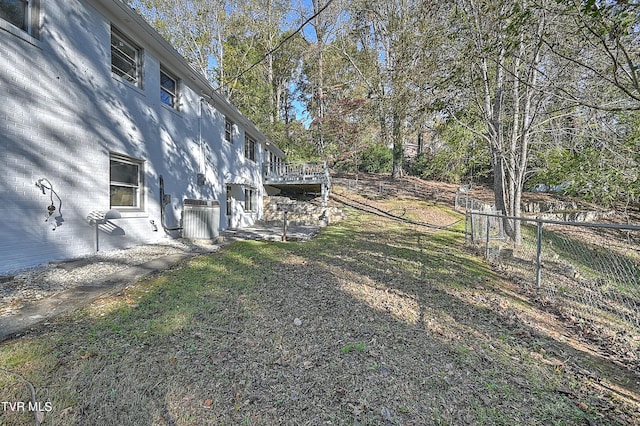 view of yard featuring a wooden deck and central AC