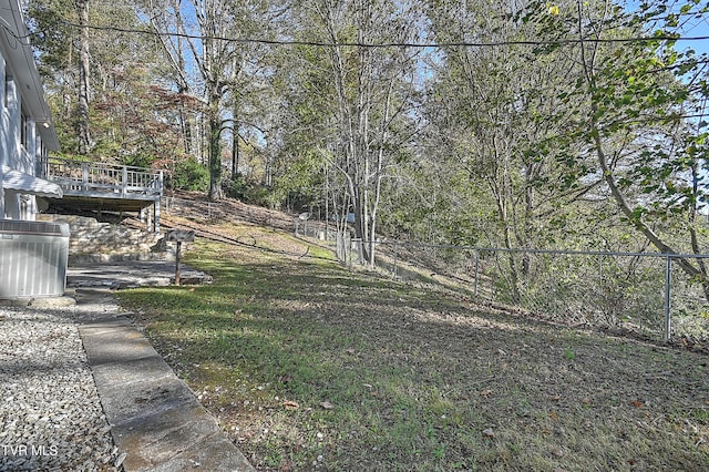 view of yard with a wooden deck and central air condition unit