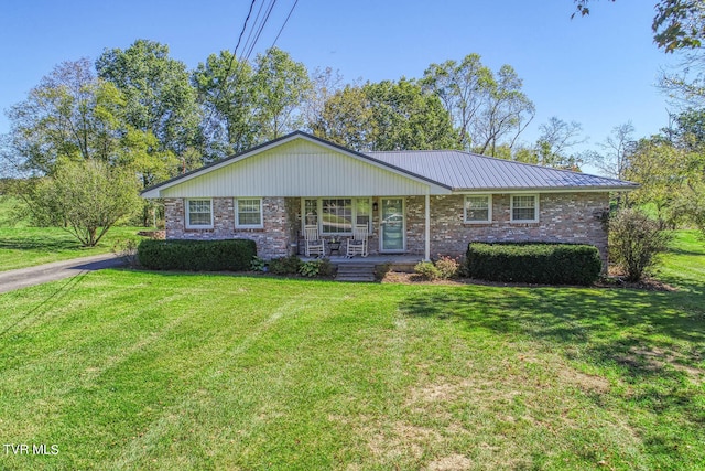 single story home featuring a front yard and covered porch