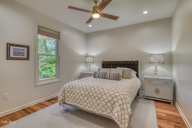 bedroom with ceiling fan and light hardwood / wood-style flooring