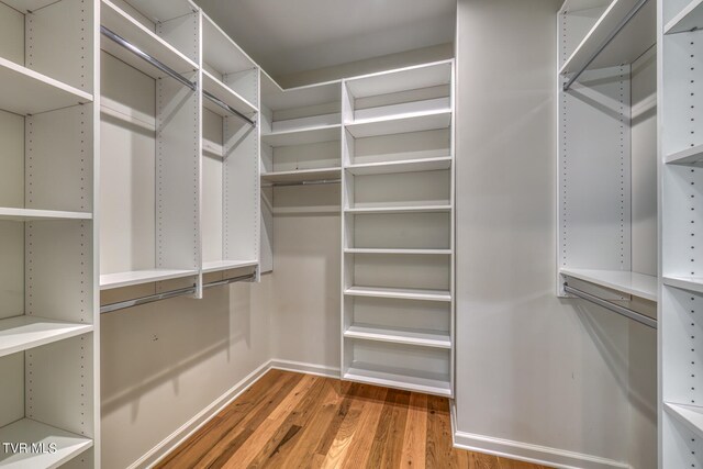 spacious closet featuring hardwood / wood-style floors