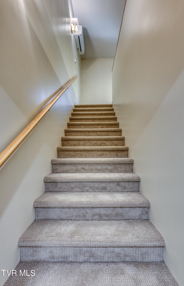 staircase with a wall mounted air conditioner