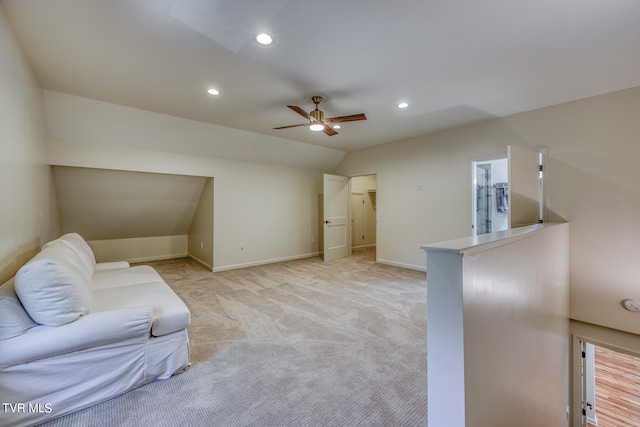 living room featuring light carpet, ceiling fan, and lofted ceiling