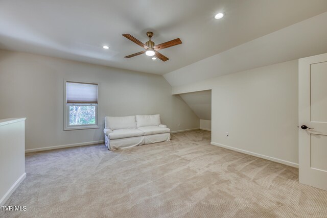 unfurnished room with lofted ceiling, light colored carpet, and ceiling fan