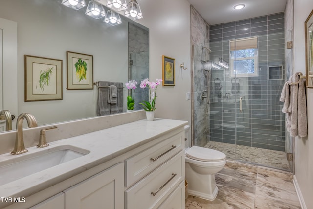 bathroom featuring vanity, walk in shower, and toilet