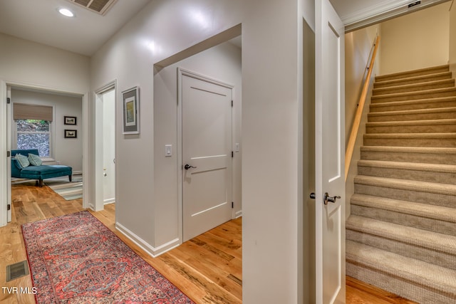 stairs with hardwood / wood-style flooring