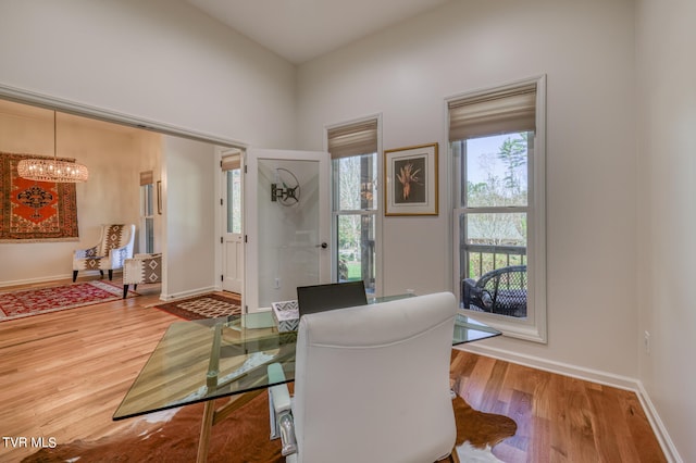 interior space with hardwood / wood-style floors and an inviting chandelier