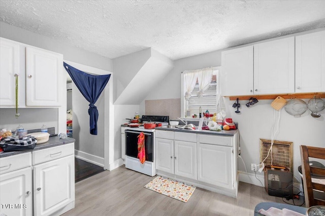 kitchen with white cabinets and electric range