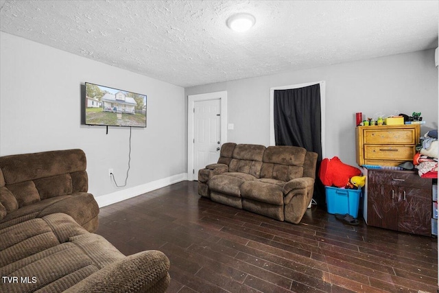 living room featuring dark hardwood / wood-style flooring and a textured ceiling