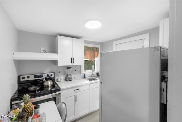 kitchen featuring white cabinetry, sink, wall chimney range hood, white refrigerator, and stainless steel electric stove