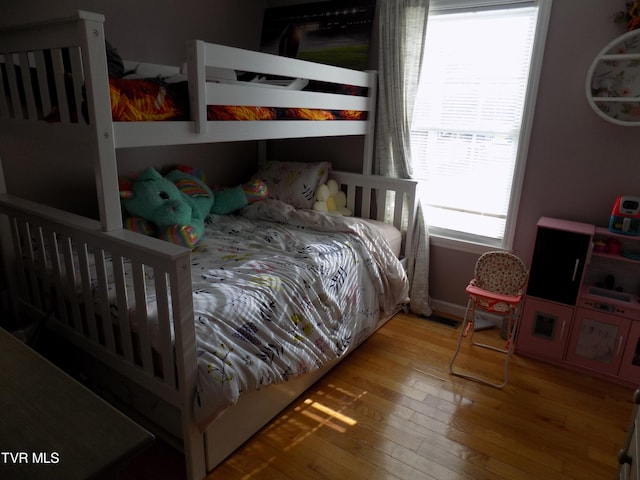 bedroom featuring light hardwood / wood-style flooring and multiple windows