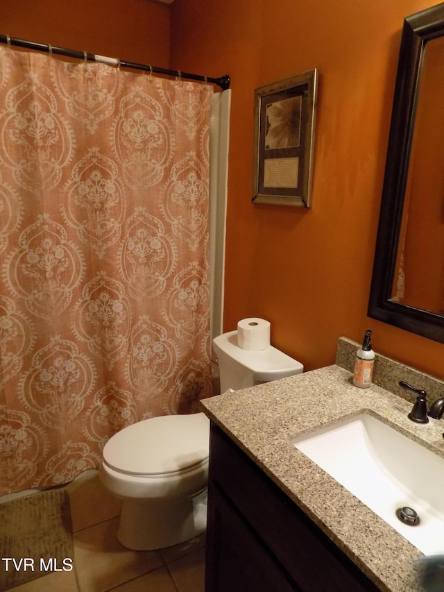 bathroom with vanity, tile patterned flooring, and toilet