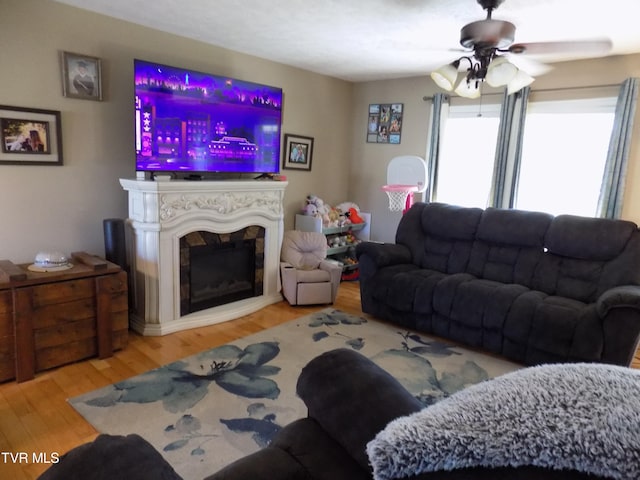 living room featuring ceiling fan and light hardwood / wood-style floors