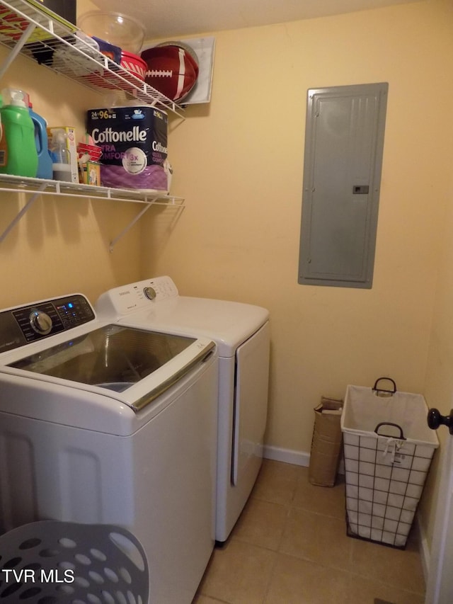 laundry area featuring electric panel, separate washer and dryer, and light tile patterned floors