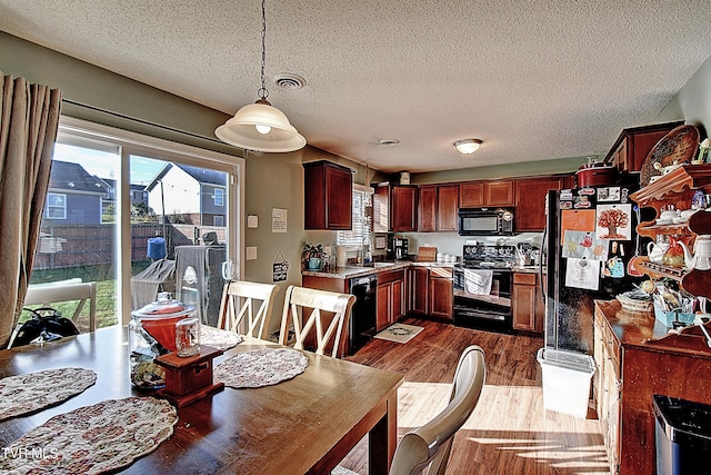 dining area with sink, dark hardwood / wood-style floors, and a textured ceiling