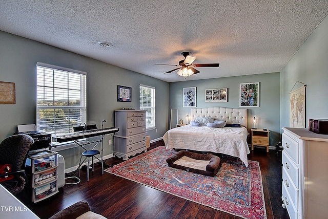 bedroom featuring ceiling fan, a textured ceiling, and dark wood-type flooring