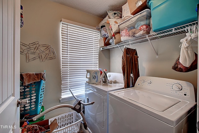 washroom featuring independent washer and dryer and a textured ceiling