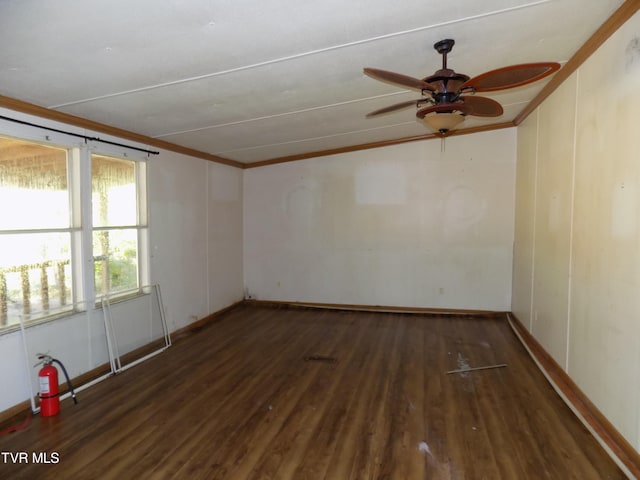 spare room with ceiling fan, dark hardwood / wood-style floors, and crown molding