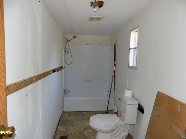 bathroom featuring shower / tub combination and toilet