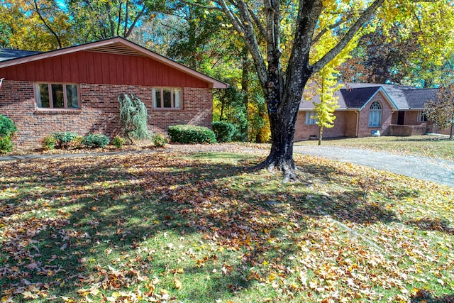 view of side of property with a lawn