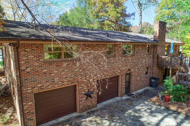 view of front facade featuring a garage and a wooden deck