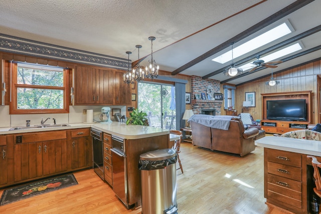 kitchen featuring a brick fireplace, light hardwood / wood-style floors, wooden walls, and kitchen peninsula