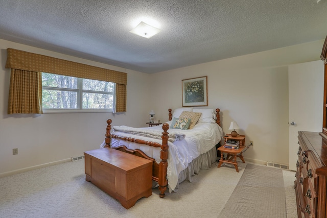 carpeted bedroom featuring a textured ceiling