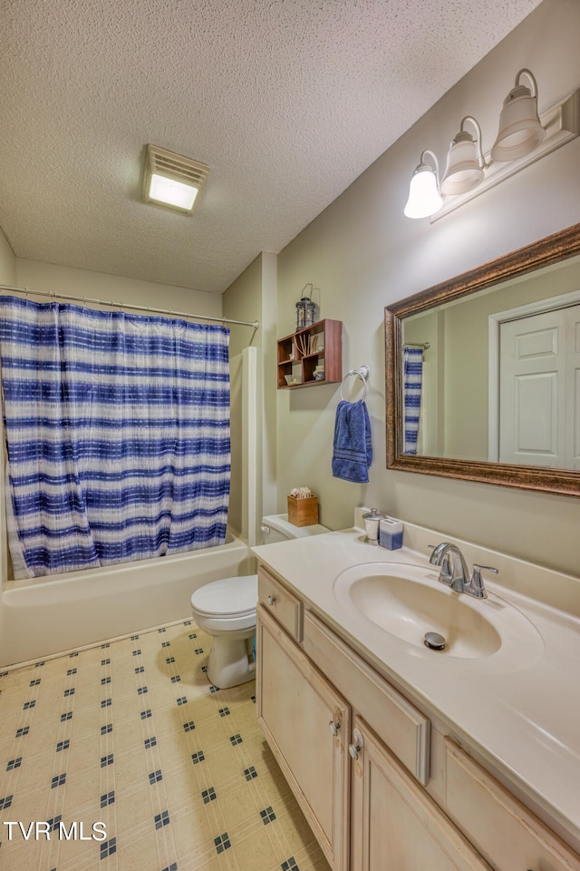 full bathroom with vanity, a textured ceiling, shower / bath combination with curtain, and toilet