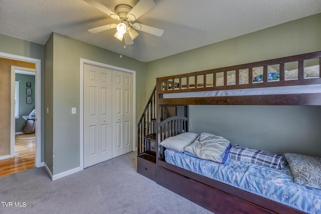 105 Buckner Dr, Roan Mountain, TN 37687 - bedroom with a ceiling fan, a textured ceiling, a closet, carpet, and baseboards