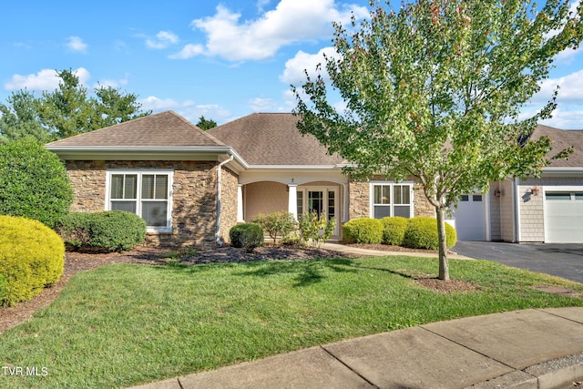 ranch-style home featuring a garage and a front lawn