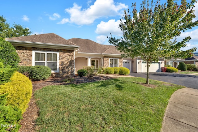 view of front of home featuring a front yard and a garage